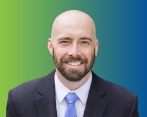 Headshot of Spencer Gore on a green-to-blue gradient background.
