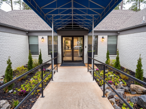 exterior shot of front door with blue awning over walkway