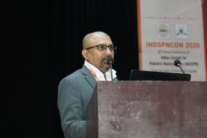 Dr. Mohana Rao Patibandla presenting as faculty speaker at INDSPNCON 2026 conference at AIIMS Rishikesh on pediatric neurosurgery topics.