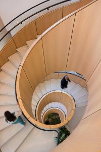 spiral staircse in terrazzo with wooden stairwell