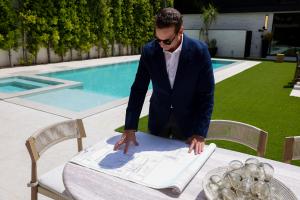 Ray Lyon and the Ray Lyon Realty Group team standing together smiling outside a luxury home in Santa Monica, California.
