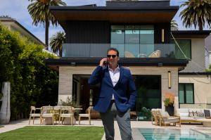 Graphic showing a five-star rating and a badge celebrating Ray Lyon Realty Group as Yelp's top rated real estate agent in Santa Monica.