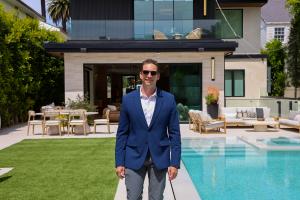 Ray Lyon discussing a real estate listing presentation and market data with homeowners in their Santa Monica living room.