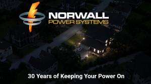 A home with lights is the only house with power in a dark neighborhood during a power outage. The standby generator in the yard restored power seconds after the power went out. Text reads: Norwall PowerSystems. 30 Years of Keeping Your Power On