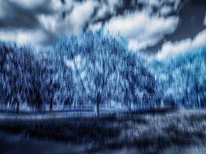 Echoes Beyond Blue – Abstract ICM landscape photograph with blue tones, blurred trees, sky, shadow, and atmospheric motion