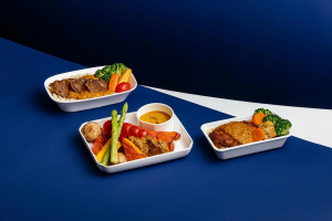 China Airlines inflight meal trays featuring lobster, braised beef, vegetables, and rice dishes served in different cabin classes.