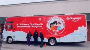 Colgate Bright Smiles, Bright Futures mobile dental van providing free dental screenings for families at a Chicago community health event