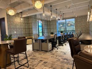 Coworking space on the 4th floor at Two Doral featuring modern desks, open seating, and a bright collaborative workspace.