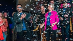 Elevator Co-Warehousing leadership and team celebrate the North Kansas City Grand Opening as silver confetti rains down following the official ribbon cutting ceremony.