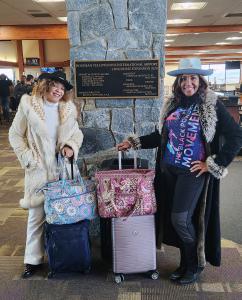 Co-Founders D. Lewis aka “Ms. Black Powder” and Deidra Ragland arrive at a Park City resort in stylish winter fashion with luggage.