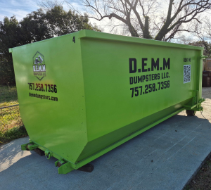 Green 20-yard roll-off dumpster from D.E.M.M. Dumpsters with phone number, website, and QR code on the side panel.