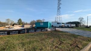 Trash Pandy teal dumpster at commercial masonry construction site in Rutherford County TN