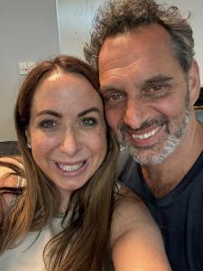 VIP Ignite Co-Founder Alycia Kaback and comedian, actor, and podcast host Geno Bisconte smile together in a close-up photo, reflecting the professional relationship between VIP Ignite's talent development leadership and the working entertainment professio