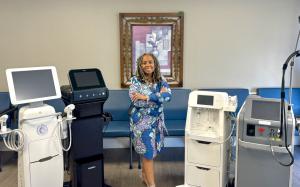 Dr. Jawan Ayer MD stands with four medical aesthetic devices including the Candela GentleMax Pro, Candela Glace, Candela Matrix Pro and INDIBA Radiofrequency system at Florida Weight Loss and Wellness Clinic in Tampa Florida