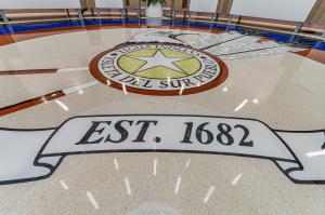 terrazzo medallion showing "est. 1682" in terrazzo
