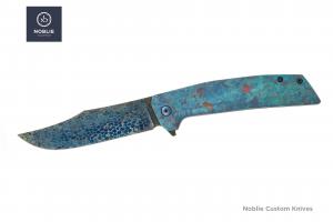 Noblie folding knife with Bertie Rietveld Dragonskin Damascus blade and blue crystallized titanium handle