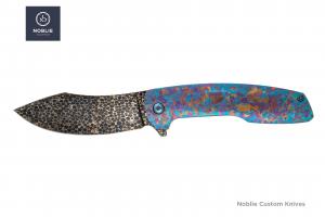 Noblie-made folding knife with Dragonskin Damascus blade and multicolor crystallized titanium handle
