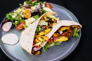 Chef Serge Krikorian's Lebanese-inspired Mediterranean Chicken with Garlic Aioli, served with a fresh garden salad by Vibrant Occasions Catering.