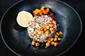 Vibrant Occasions Catering's Vegetable Quinoa Pilaf with roasted chickpeas and Mediterranean chicken, as demonstrated by Chef Serge Krikorian on THV11's The Vine.