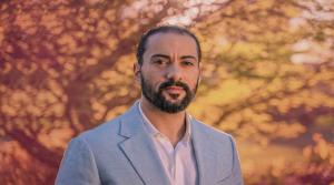 Laith Eskandar looks at the camera while standing in front of a tree in Vancouver, BC