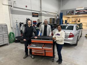 Image of Giovanni Rossi, Frank Dominguez and Sophia Maloney surrounding donated tool set.