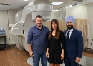 RTS Vice President of Clinic Services Brice Hamilton, CPRCC Radiation Oncology Manager Nicole Peaper, , and CPRCC Radiation OncologistDr. Beant Gill pose in the treatment room at CPRCC.
