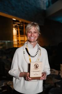 Roxanne Joyal, Founder and CEO of &BACK COFFEE, holding the 2026 Canadian Fair Trade Award for Producer Impact and Leadership at the Fairtrade Canada conference in Winnipeg.