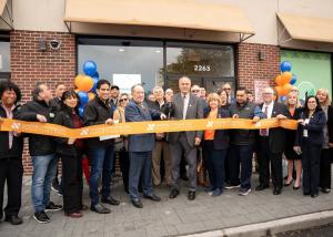 Nassau Financial Federal Credit Union CEO John T. DeCelle and community members cut the ribbon at the grand opening of the Farmingdale branch on Route 110
