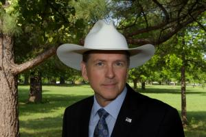 Photo of Gary Ty England in a suit and Cowboy hat