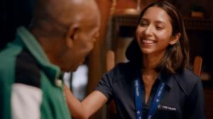 A VNS Health nurse smiles and comforts her patient