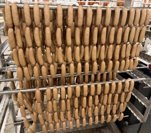 Hanging pork breakfast sausages ready to be naturally smoked on Cherrywood