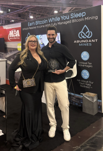 Heather Richmond presenting the 2026 Satos Award to Beau Turner, Owner of Abundant Mines, winner of the Mining and Energy category at the 2026 Satos Awards during Bitcoin Conference week in Las Vegas.