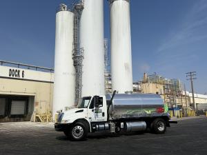Used cooking oil collection truck at a recycling facility in Los Angeles handling yellow grease for recycling
