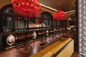 The Founders Bar decorated with red Baccarat chandeliers is a nod to the original founders of the hotel in 1911