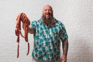 Ralph Perrazzo, owner of Snap-O-Razzo holding hot dogs
