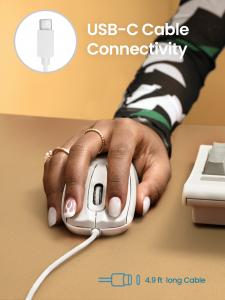 A hand resting on the PERIMICE-209CW white wired mouse on a tan desk surface. A close-up inset in the top left highlights the USB Type-C connector. Text overlay reads "USB-C Cable Connectivity" with a graphic indicating a 4.9 ft cable length.