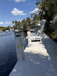 Newly installed concrete and steel seawall along an intracoastal canal in Broward County, Florida, constructed by South Florida Seawall to meet 5.0 feet NAVD88 elevation compliance standards.
