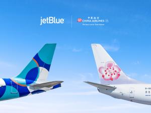 Tail sections of a JetBlue aircraft and a China Airlines aircraft positioned side by side against a blue sky, representing a new partnership between the two airlines.