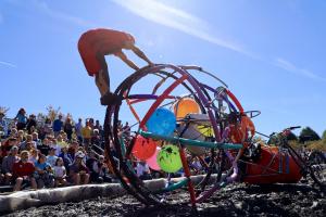 Kinetic Sculpture pilot is rotating Big Ball's  frame to get through the mud pit