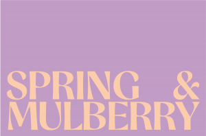 In this photo, there is the Spring & Mulberry logo written in peach, against a lavender background.