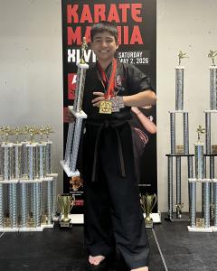 Martial Artist, Point Fighter and member of Team Canada, Eli Cooper proudly displaying his trophy, Gold and Silver medals at Karate Maynia