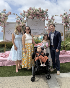 Autumn Strier, Co-Founder & CEO of Miracles for Kids with the Anselmo Family posed for a photo.
