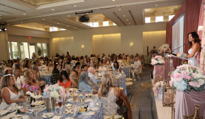 Sarah Stage speaks to a full ballroom at the 2026 Sold-Out Miracles in Bloom Tea Presented by Diamond Wish.