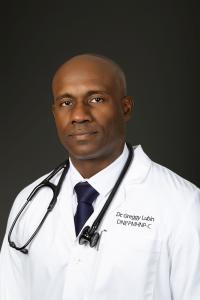 Dr. Lubin sitting in his white lab coat and a stethoscope around his neck.