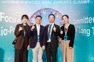 SNU Eye Clinic team members posing together at the EVO ICL APAC Summit, smiling and giving thumbs up in front of the event backdrop.