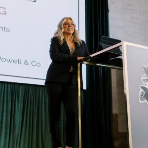 Chris Weinberg speaking at a podium during The Event Summit conference
