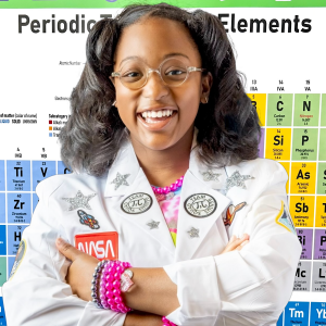 Ava standing In Front of a Periodic Tables of Elements With Her Arms Folded With Confidence