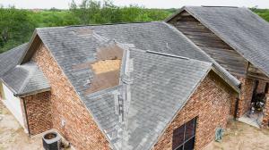 alt="A picture of wind damaged foud on a roof that was payed for by their insurance company.""