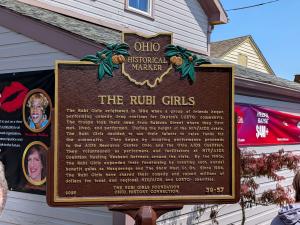Image of a cast bronze Ohio historical marker plaque, honoring the contributions of the Rubi Girls to Ohio history..