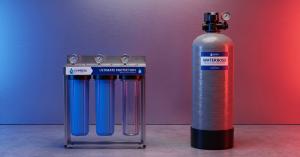 Express Water Ultimate Protection 3-stage whole house water filter system next to an Express Water WaterBoss whole house water filter tank on a concrete surface with blue and red lighting.